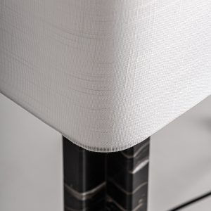Lámpara de sobremesa de estilo art deco fabricado en mármol en color negro combinado con hierro en color oro y poliéster en color blanco. Producto desmontable.