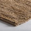 Alfombra tish de estilo boho fabricado en yute en color tonos en marrón combinado con algodón.