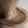 Taburete Aprica de estilo étnico fabricado en madera suar en color marrón con acabado natural.