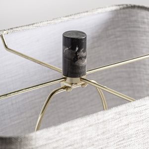 Lámpara de sobremesa Carla de estilo art deco fabricado en mármol en color negro combinado con metal en color dorado y poliéster en color arena con acabado jaspeado. Producto desmontable.