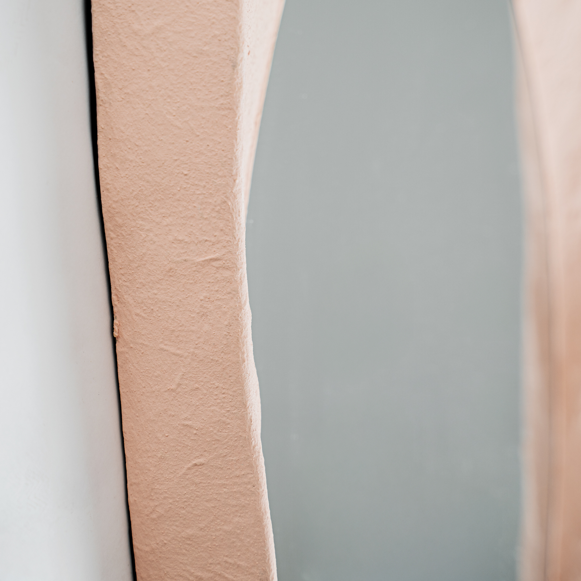 Espejo Budel de estilo contemporáneo fabricado en resina en color rosa.